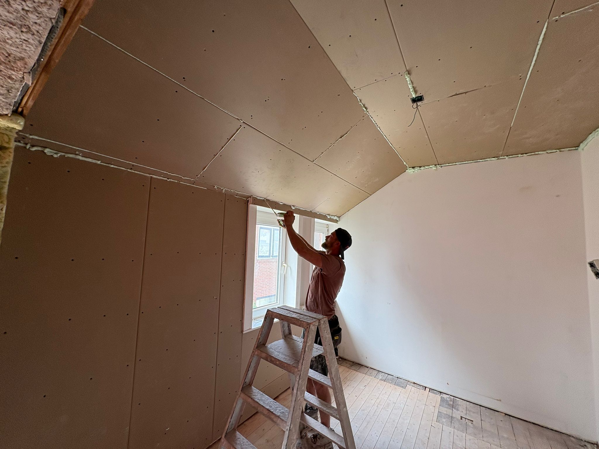 Vakman aan het werk met verlaagd plafond